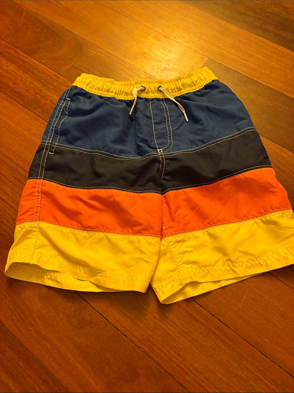 Hanna Andersson Colorblock Swim Trunks in Blue, Black, Orange & Yellow